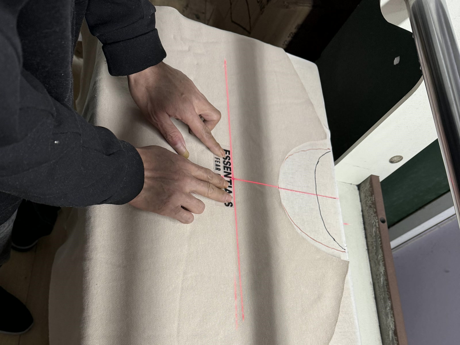 Team marking fabric on a cutting table during sample development